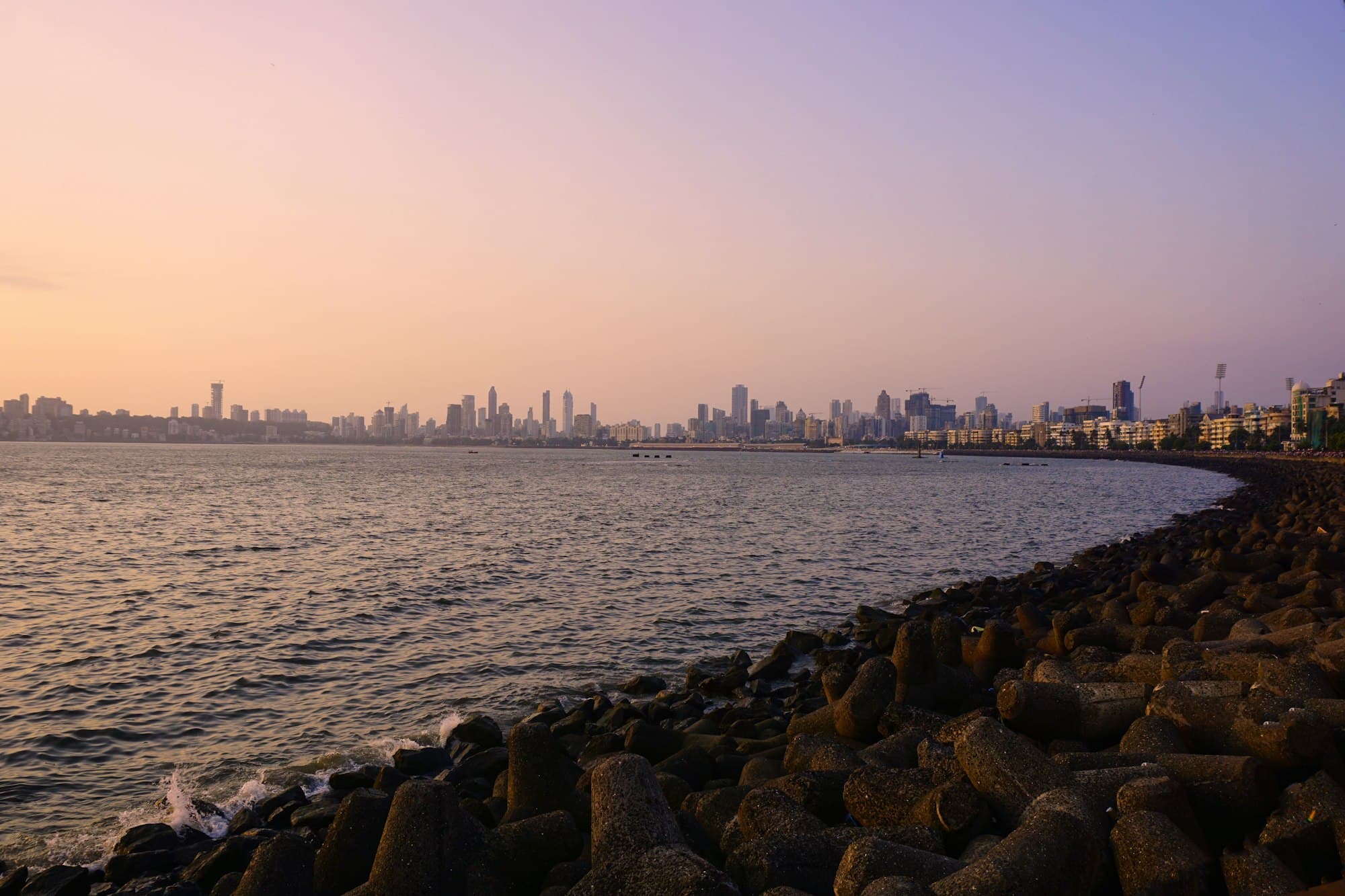 The Mumbai skyline across the sea at sunset